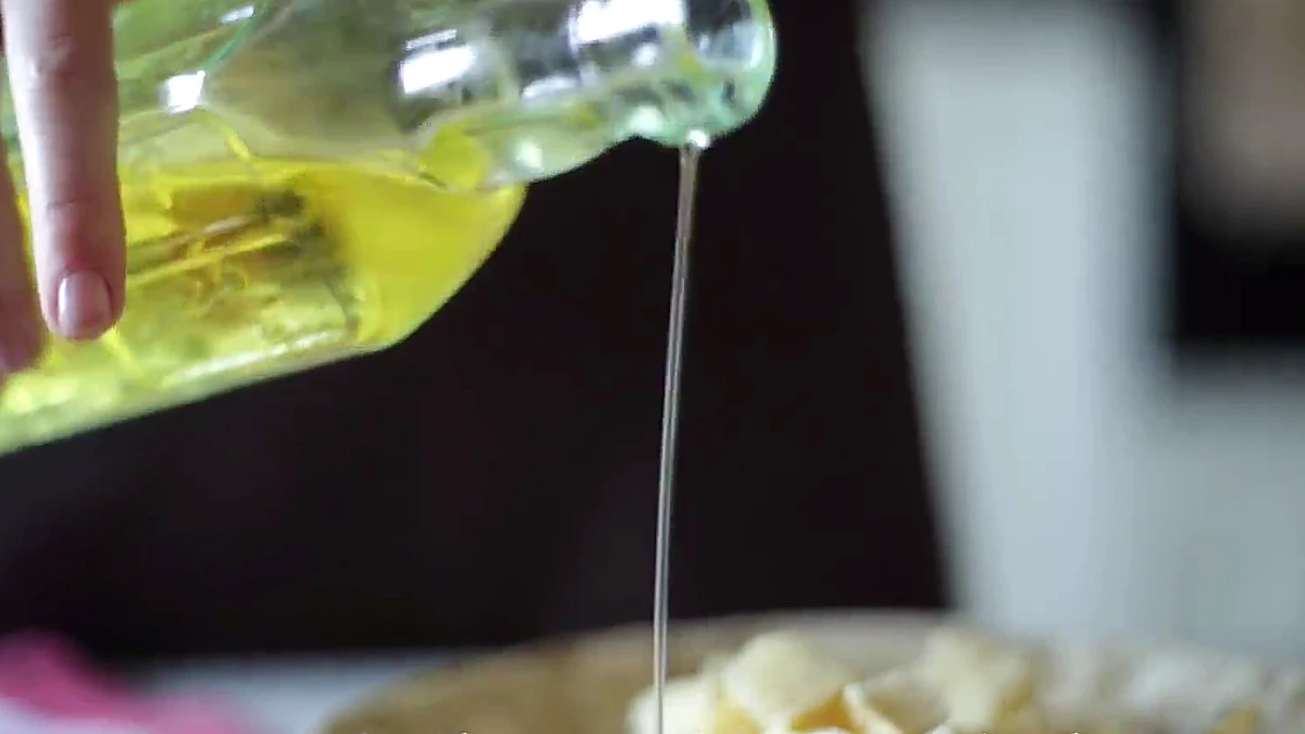 Olive oil poured over baguette cubes