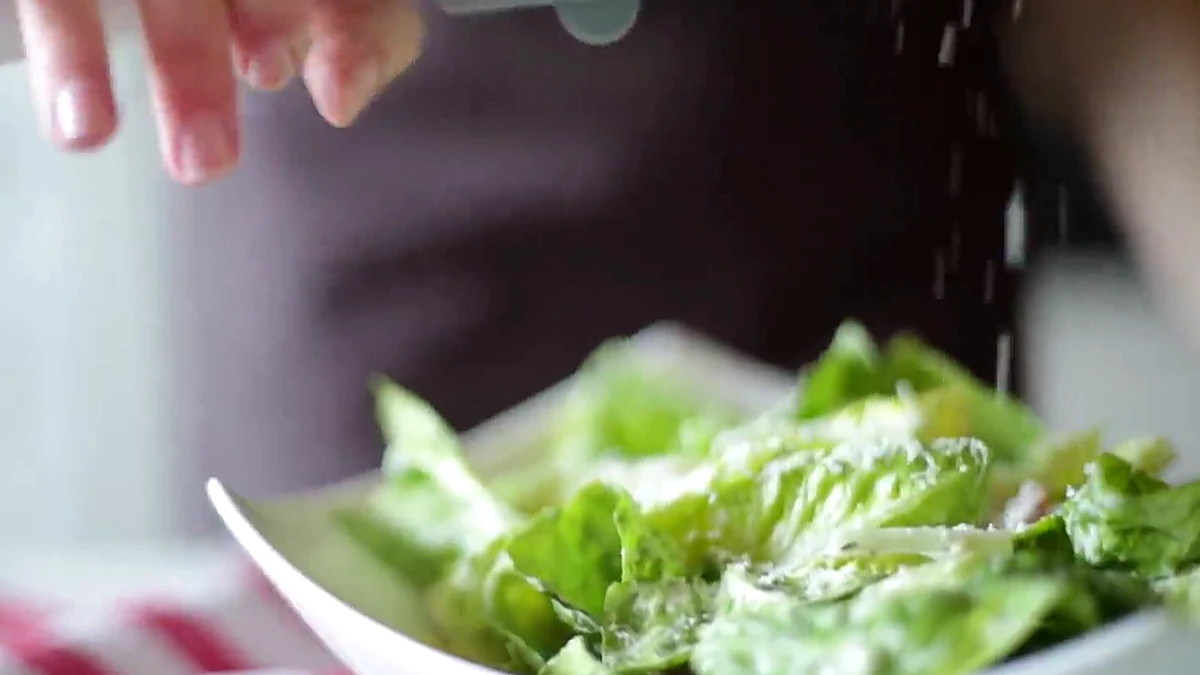 Parmesan grated over shrimp Caesar salad