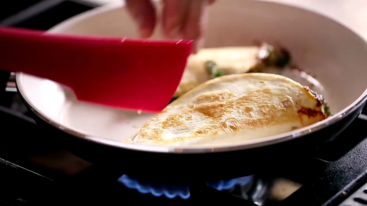 Cherry quesadilla browning in a skillet
