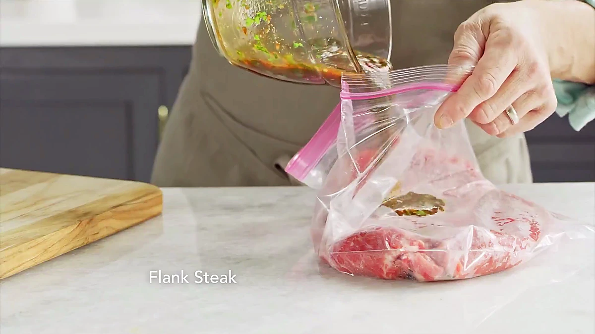 Chili herb marinade poured over flank steak in a bag