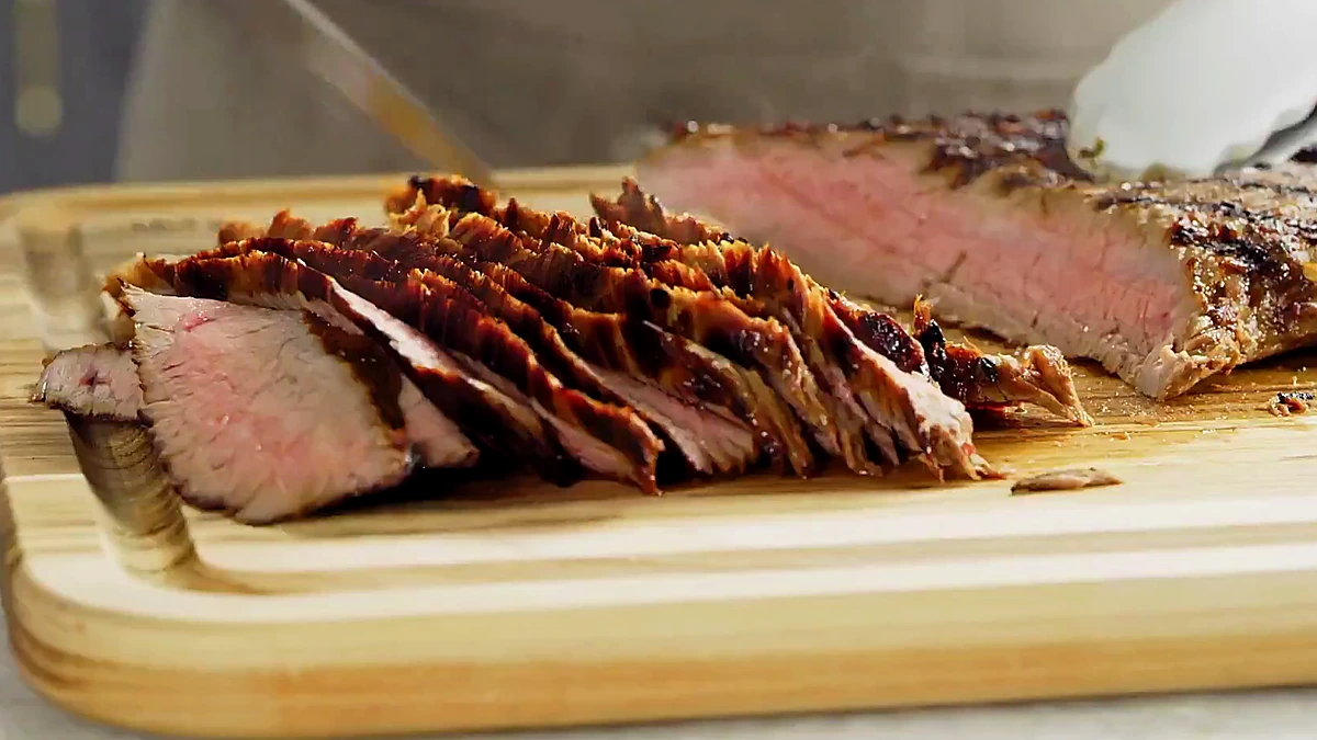 Sliced chili herb steak on a cutting board