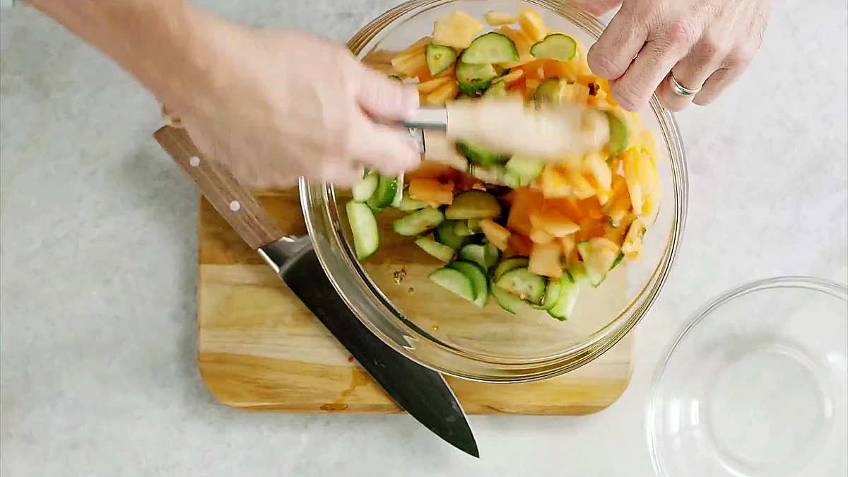 Melon cucumber salad tossed with chili herb dressing