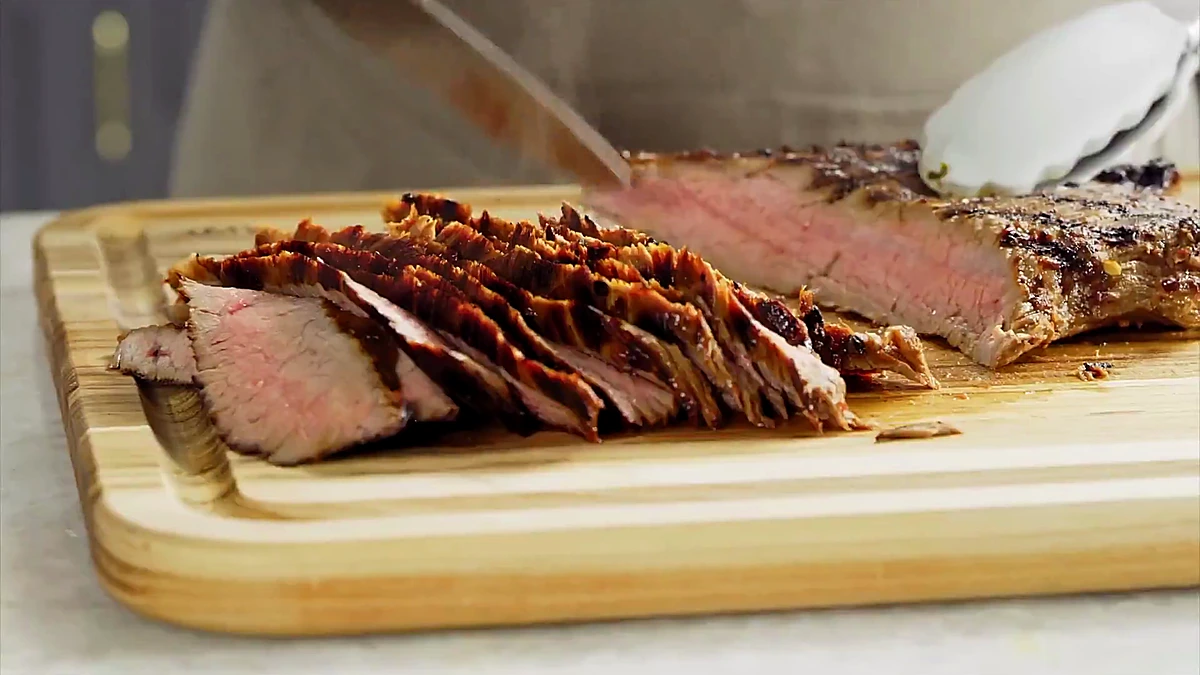 Sliced chili herb steak on a cutting board