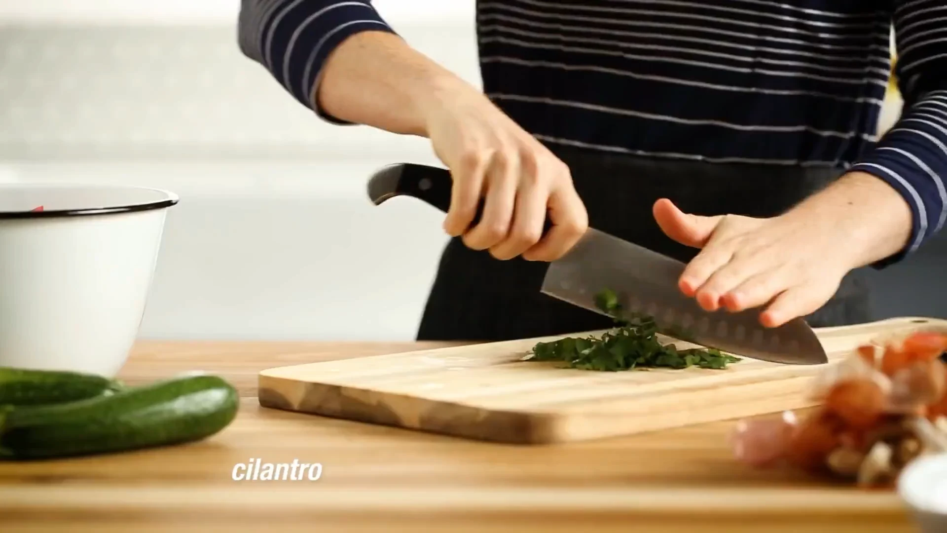 Fresh cilantro being chopped on a wooden board