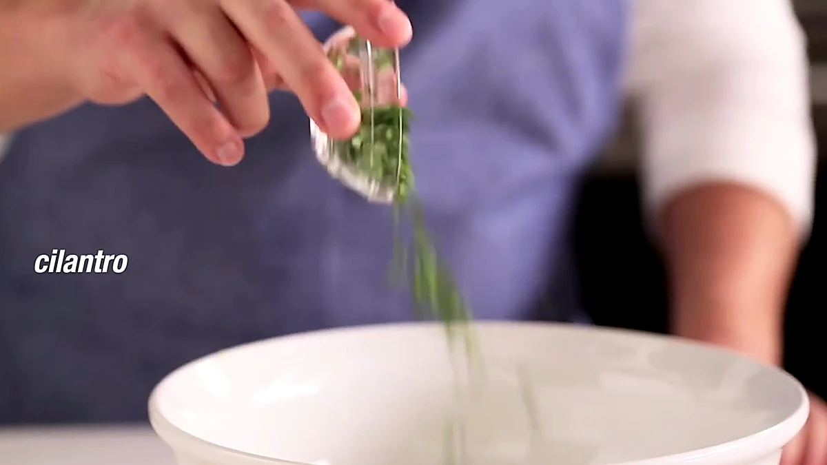 Cilantro added to the lime bowl
