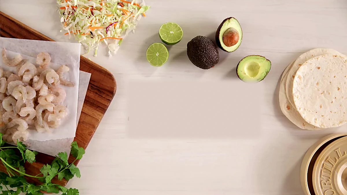 Ingredients for crispy Baja shrimp tacos arranged on a light table