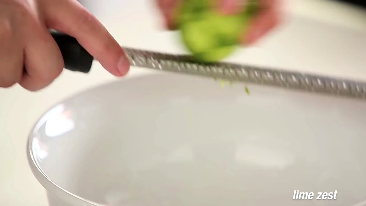 Lime zest being added to a bowl for Baja shrimp taco slaw