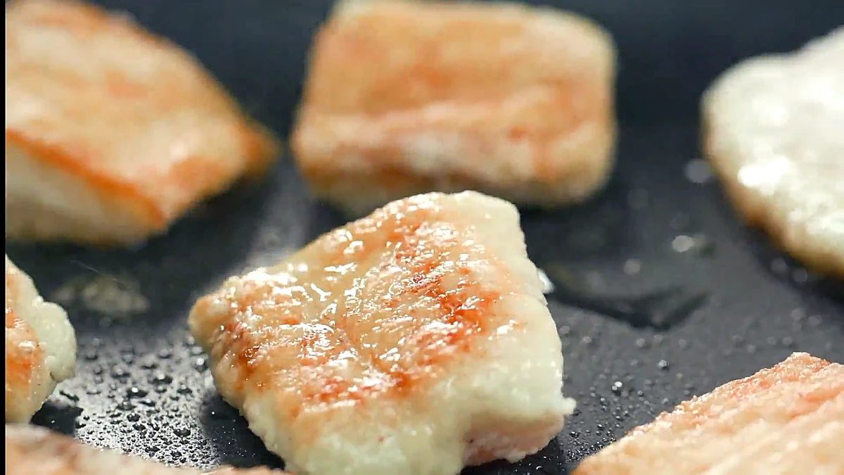 Tilapia frying until golden and crispy