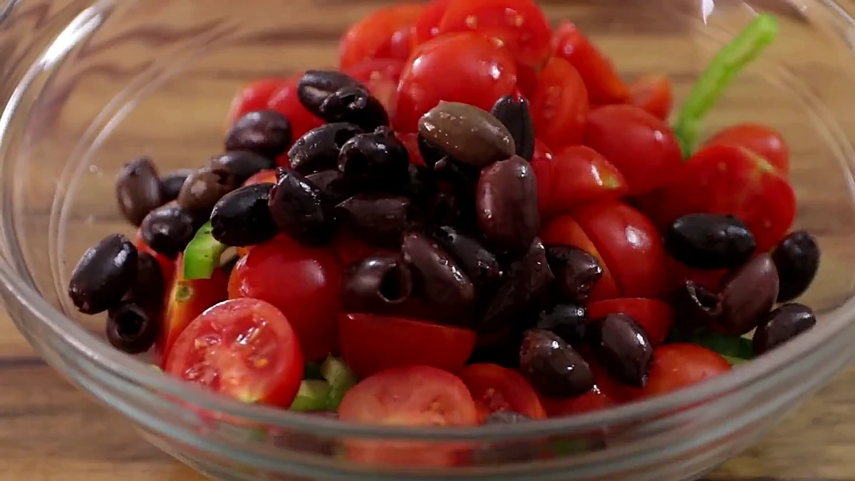 Kalamata olives added to the salad bowl