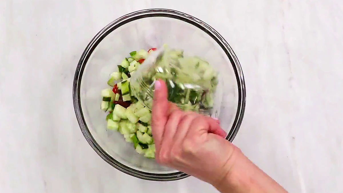 Chopped cucumber added to the Greek wrap filling