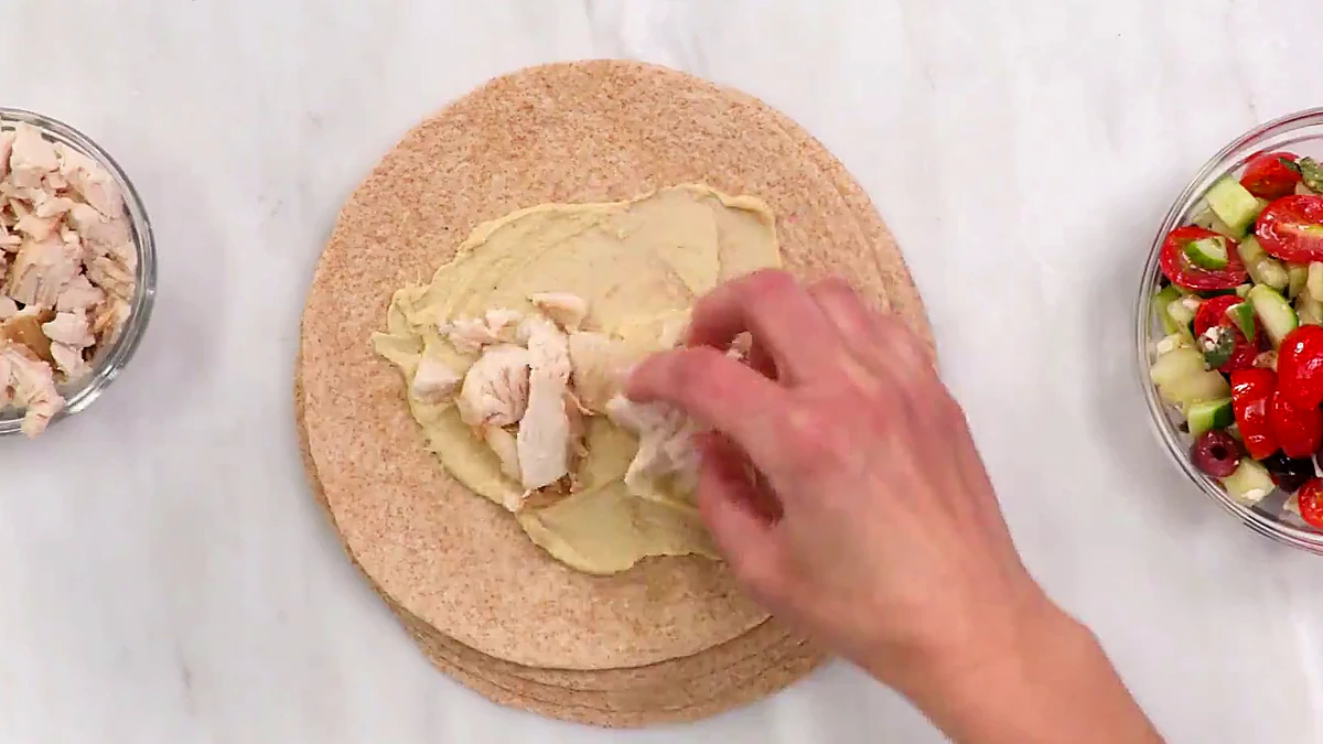 Chicken layered down the center of the tortilla