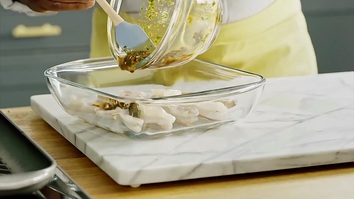 Citrus marinade poured over shrimp skewers