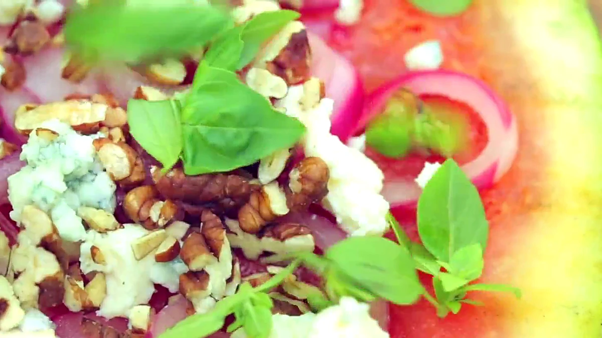 Small basil leaves added to watermelon pizza