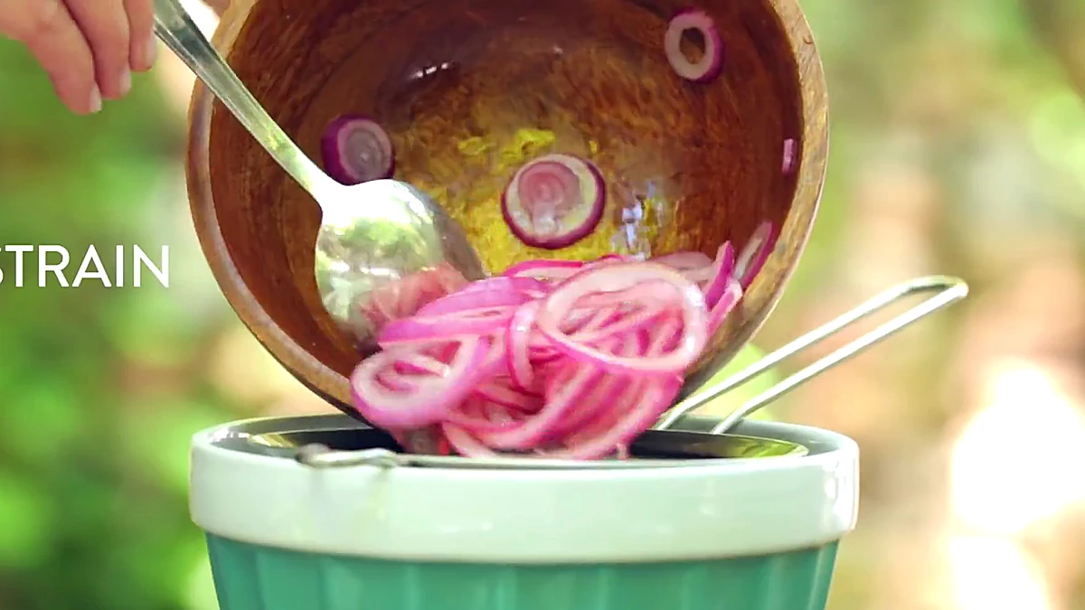 Pickled onions strained over a bowl