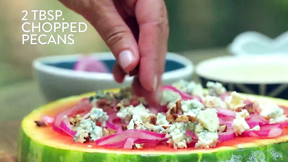 Chopped pecans sprinkled over watermelon pizza