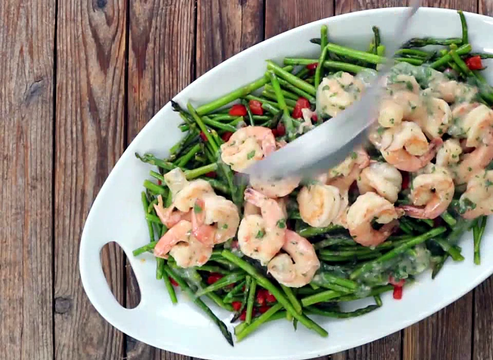 Lemon garlic shrimp spooned over asparagus and peppers