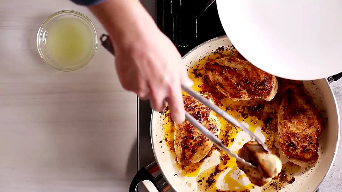 Chicken breasts browning in a skillet