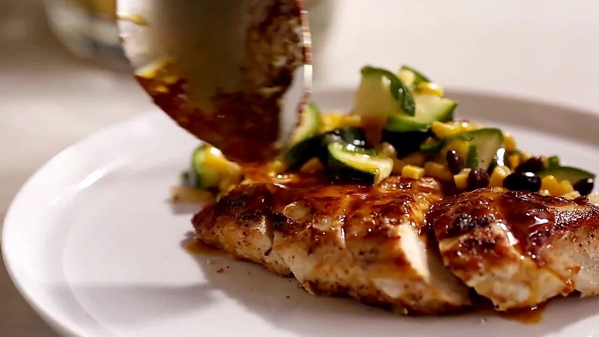 Plated lime chicken with corn zucchini salad angle