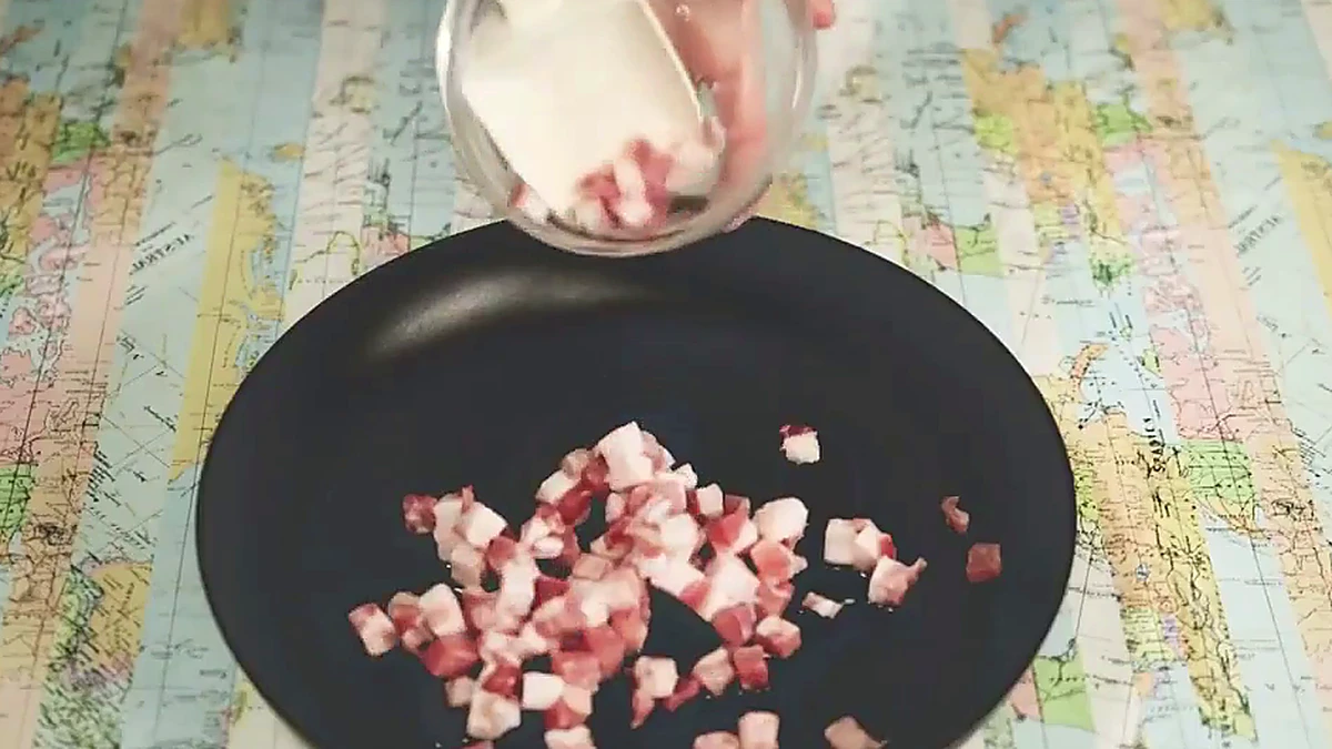 Pancetta frying in a pan