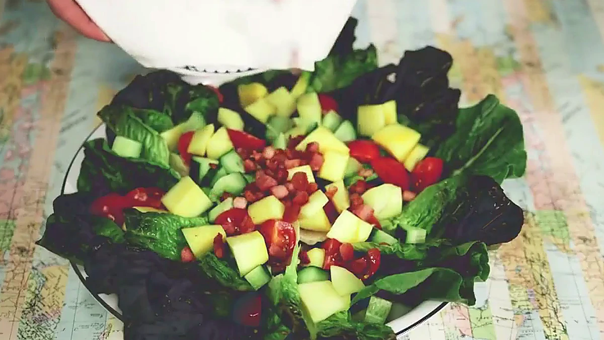 Toasted pine nuts added to mango salad