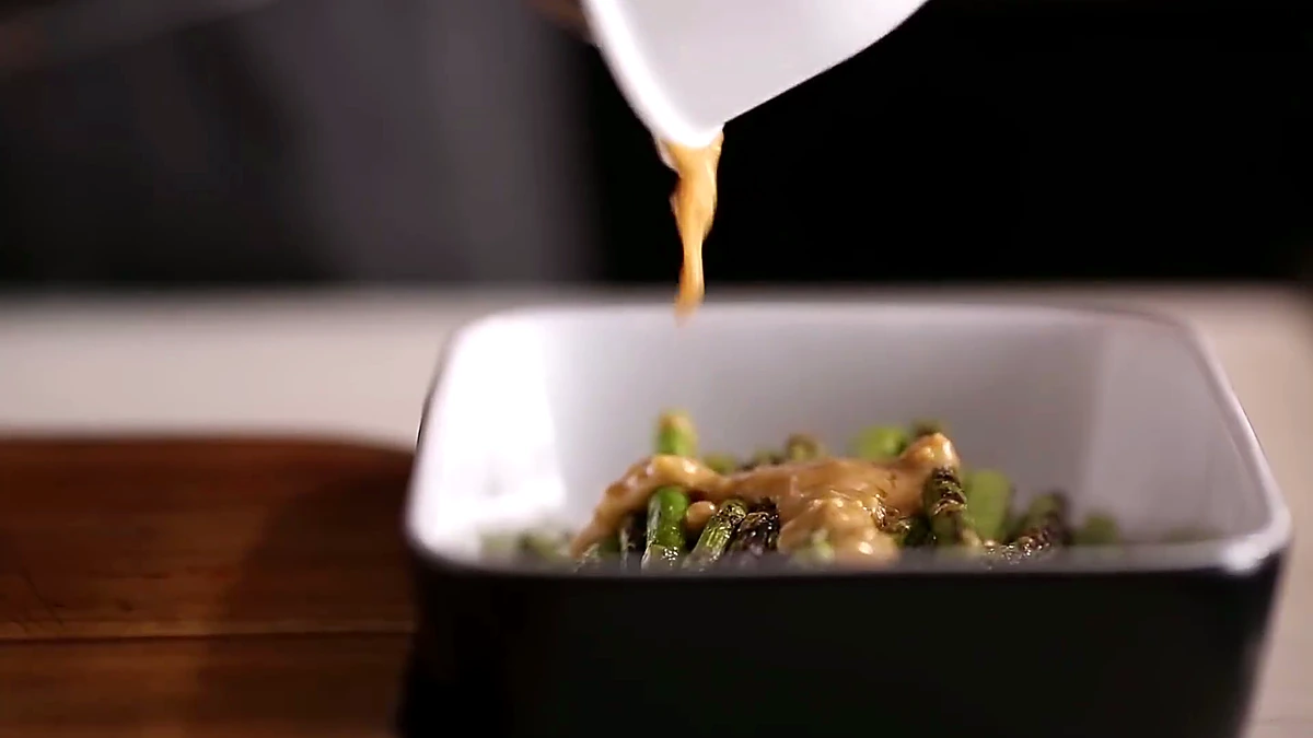 Sauce poured over grilled asparagus