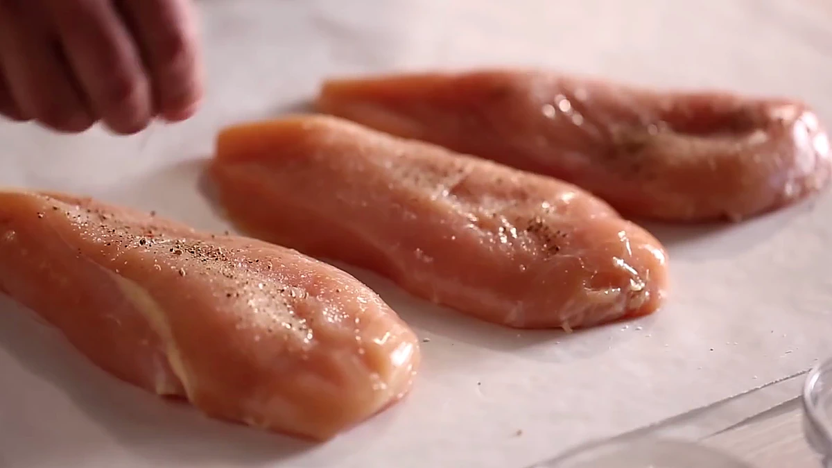 Smoked paprika sprinkled over chicken breasts