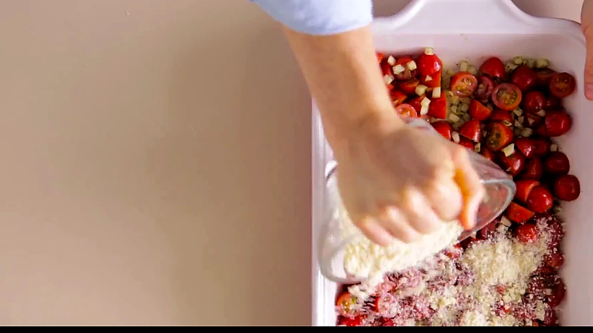 Cheese crumb topping sprinkled over tomatoes
