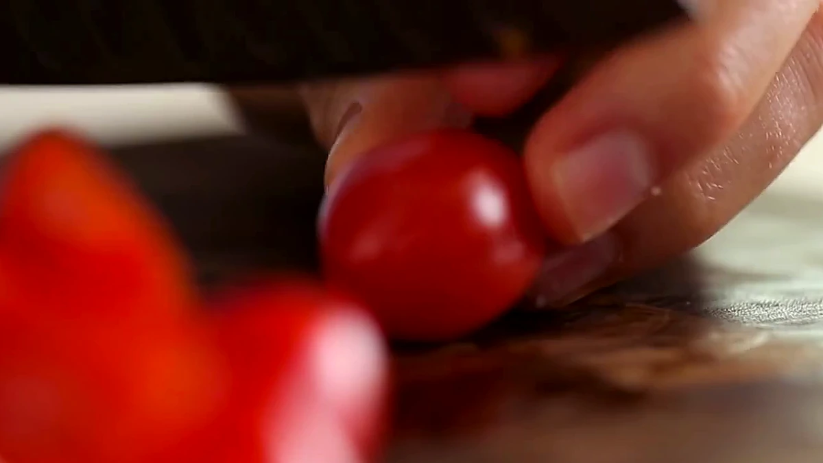 Grape tomatoes being halved