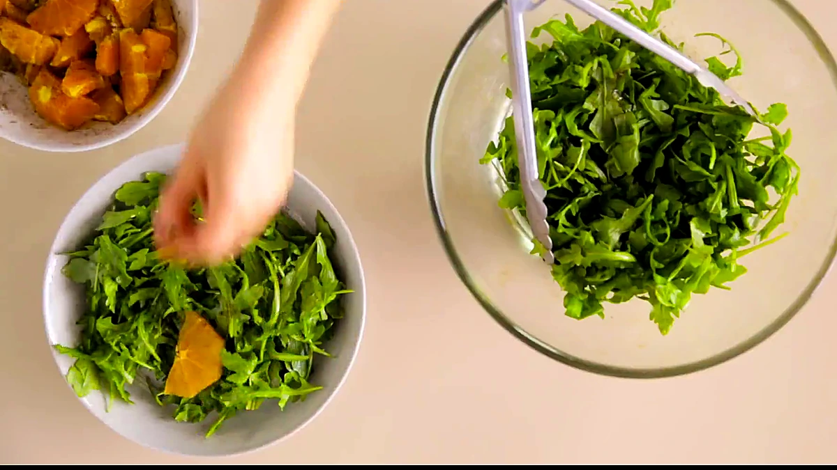 Spiced orange slices added to arugula