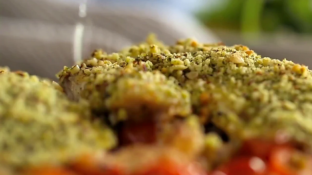 Close view of pesto fish tomato bake with lemon