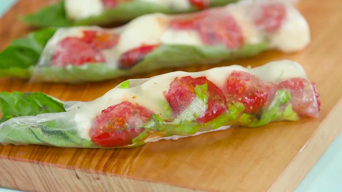 Close angle of roasted tomato Caprese summer rolls