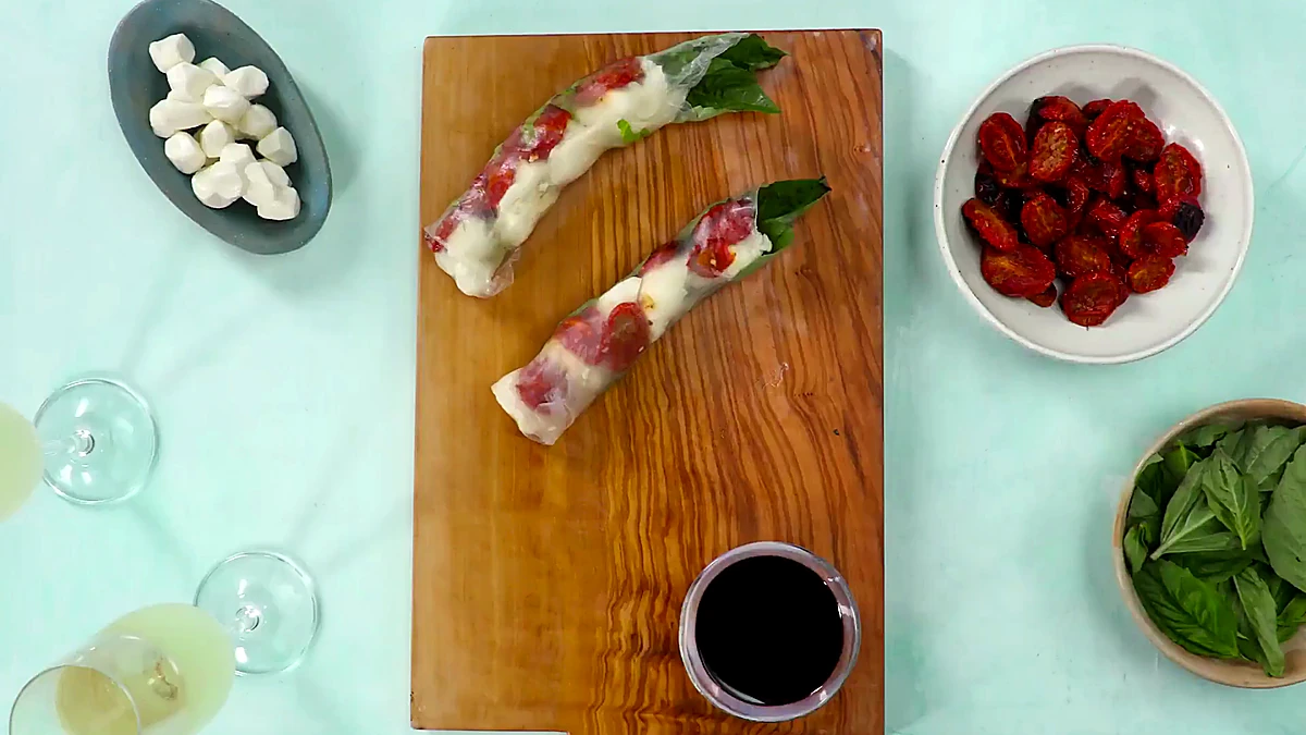 Roasted tomato Caprese summer roll ingredients on a board