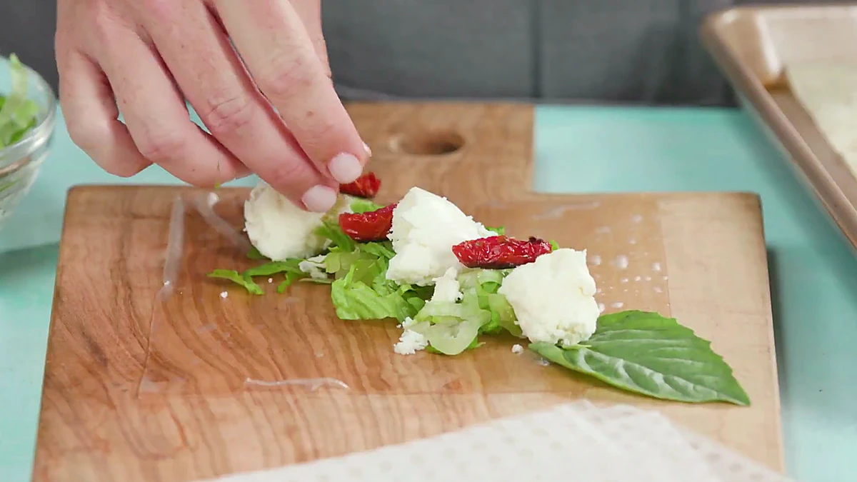 Roasted tomatoes added over mozzarella in rice paper