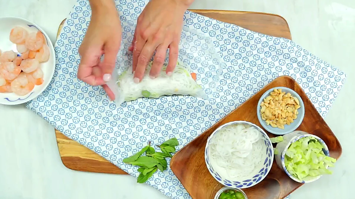 Bottom edge of rice paper folded over shrimp filling