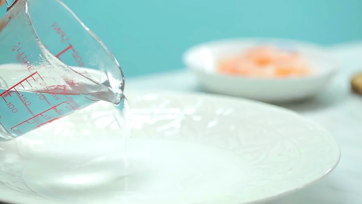 Water poured onto a plate for rice paper