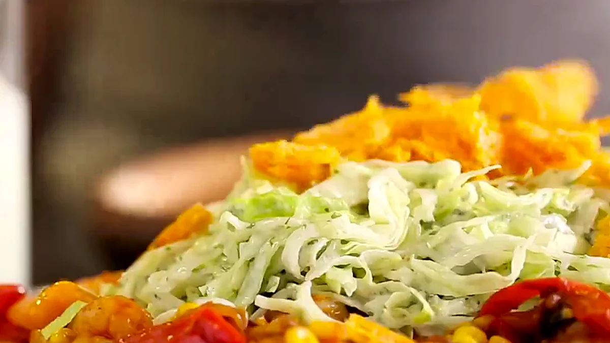 Cheesy tostada crumble added to shrimp tostada salad