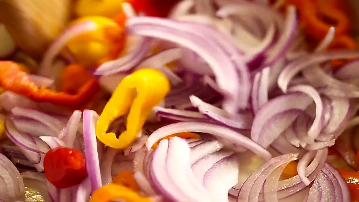 Peppers and red onion in a skillet