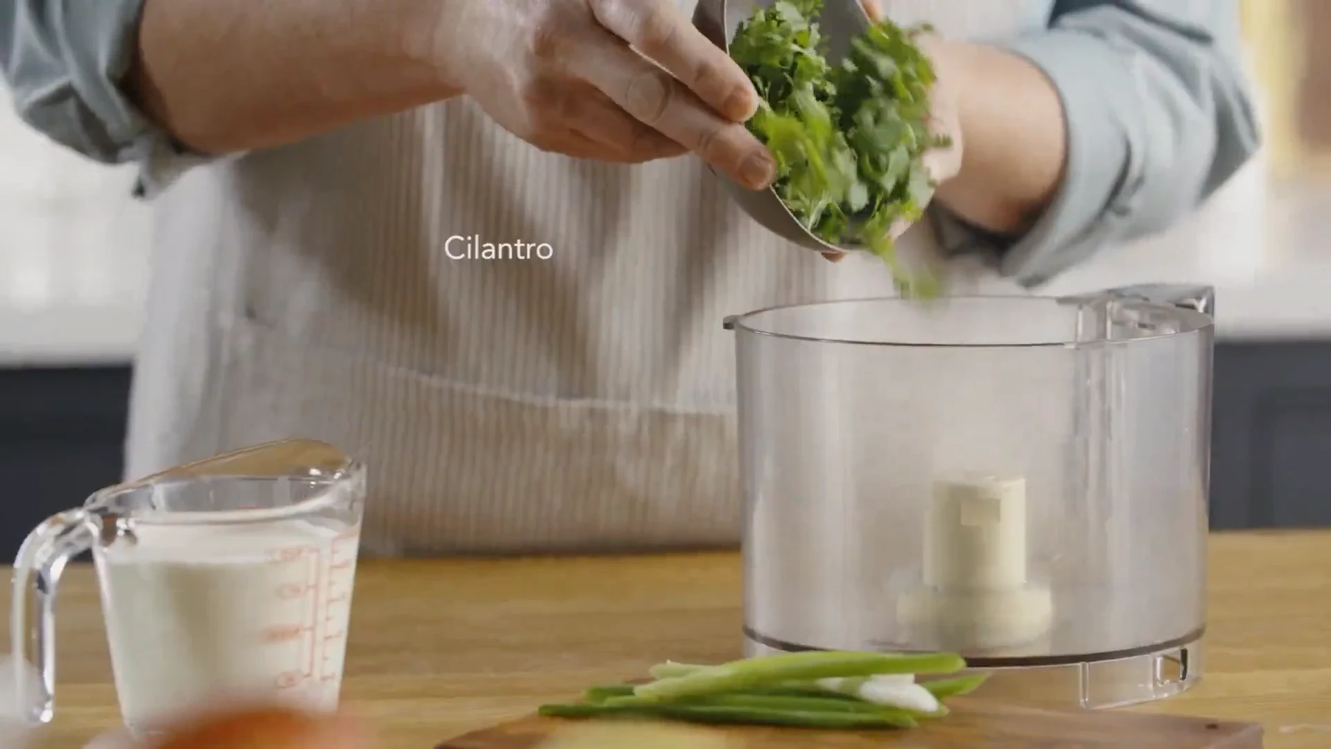 Cilantro added to a food processor for the verde sauce
