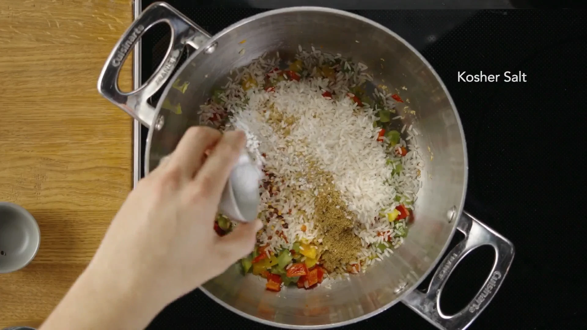 Kosher salt being added to the rice