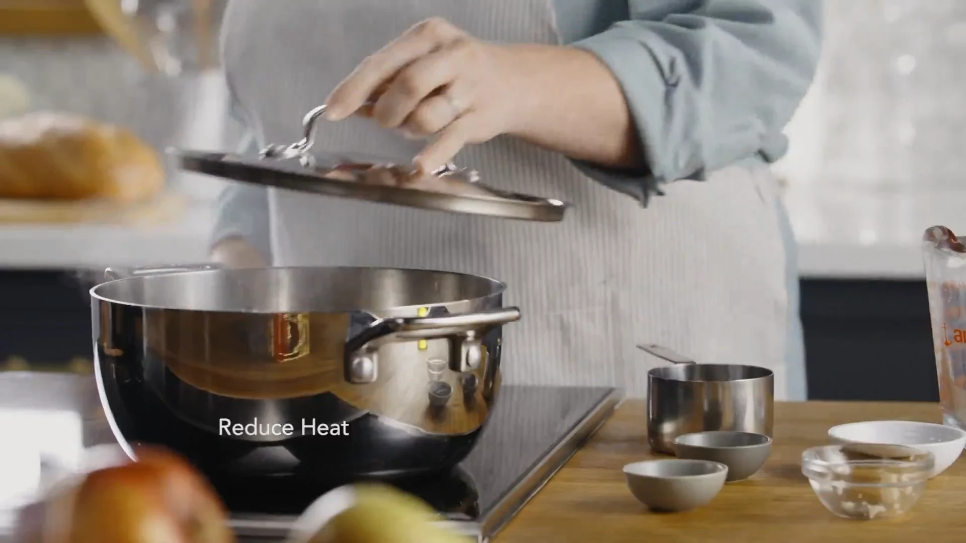 Lid being placed on the pot to simmer the rice