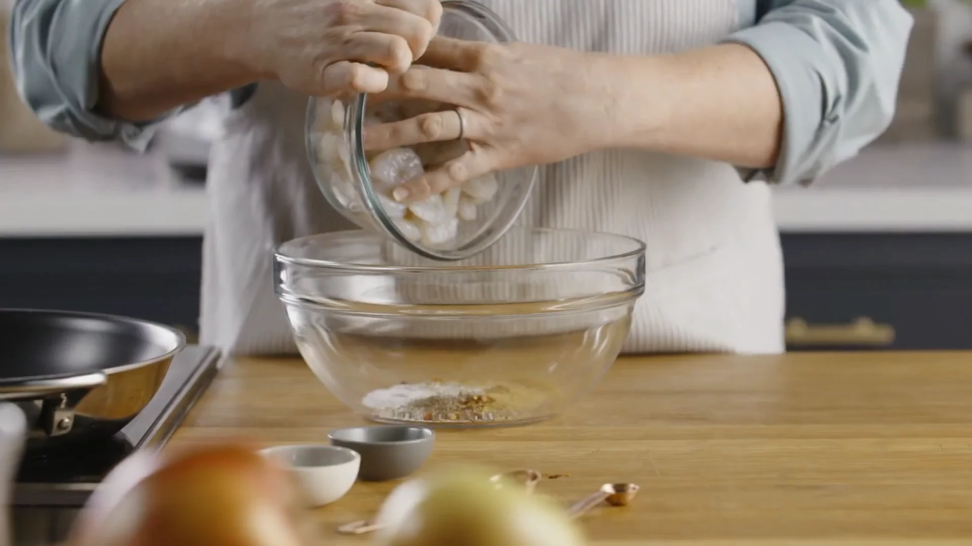 Shrimp added to the spice mixture in a bowl