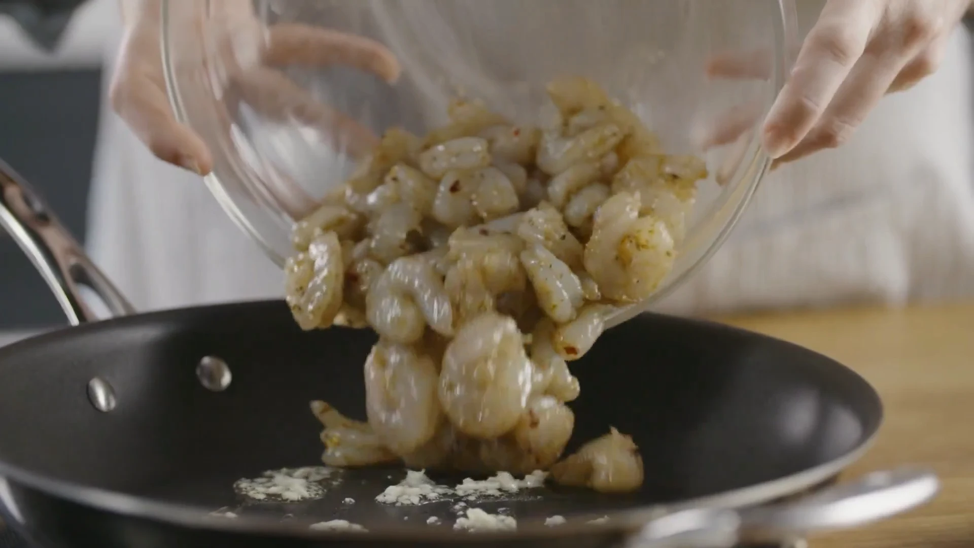 Seasoned shrimp tipped into the skillet