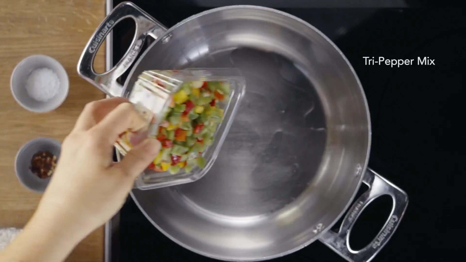 Tri-pepper mix being added to the pot