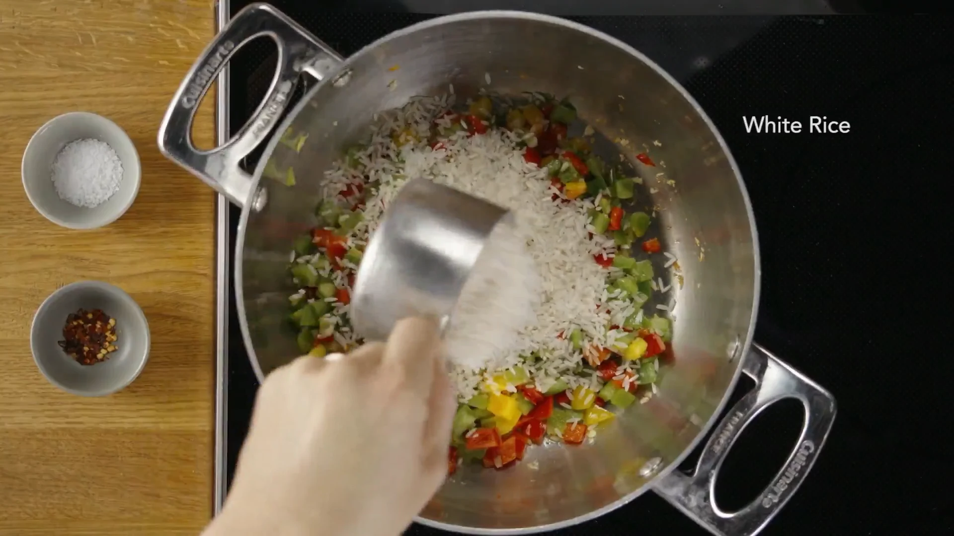 White rice added to peppers in the pot