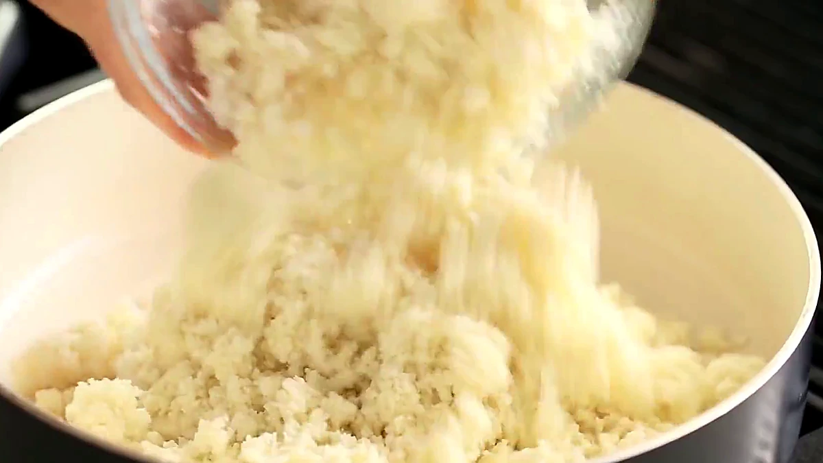 Cauliflower rice mixture added to a pan