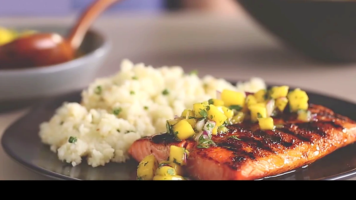 Spiced salmon served with cauliflower rice from a side angle