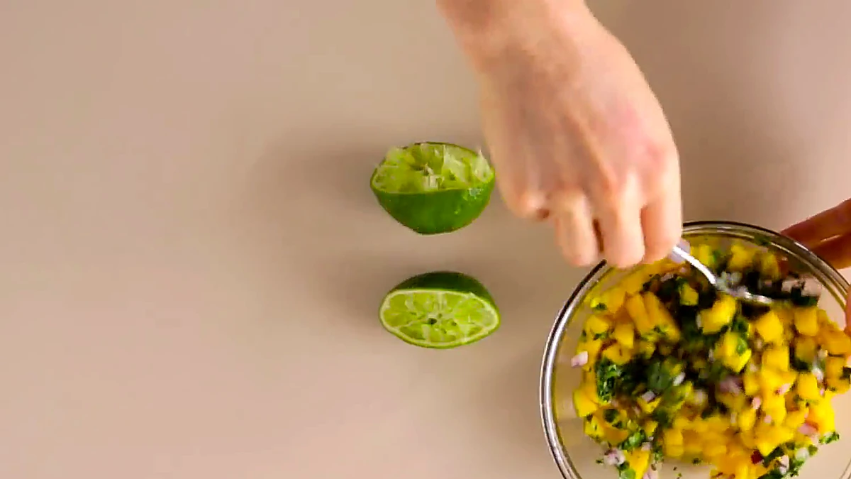Mango salsa mixed in a glass bowl