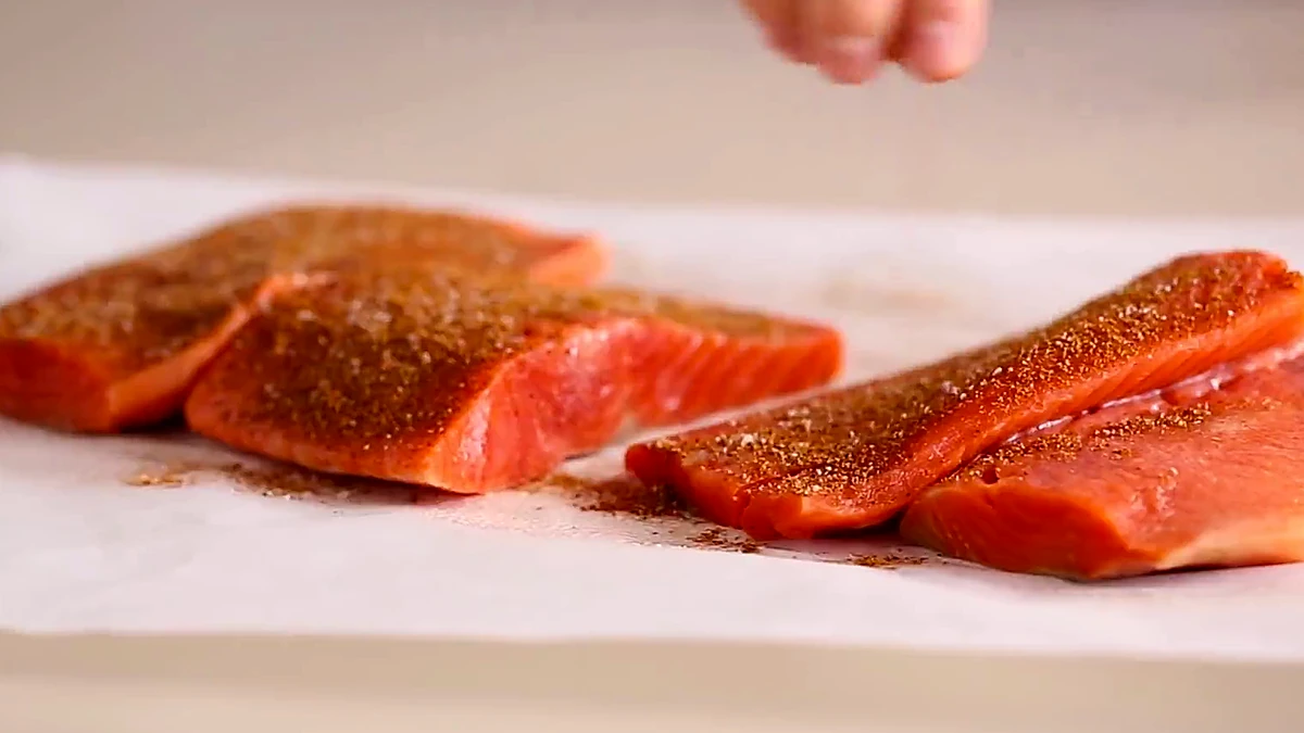 Spice rub sprinkled over salmon fillets