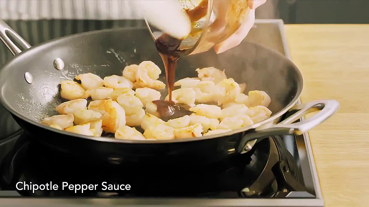 Chipotle glaze added to cooked shrimp