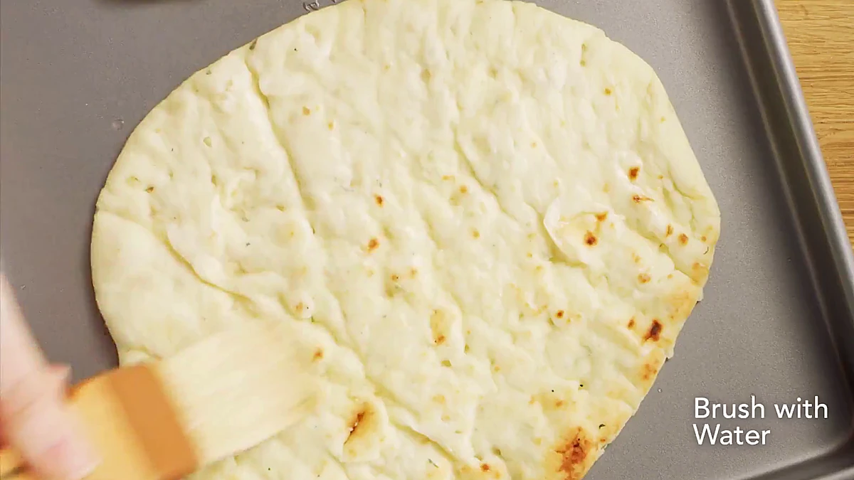 Naan brushed with water before warming